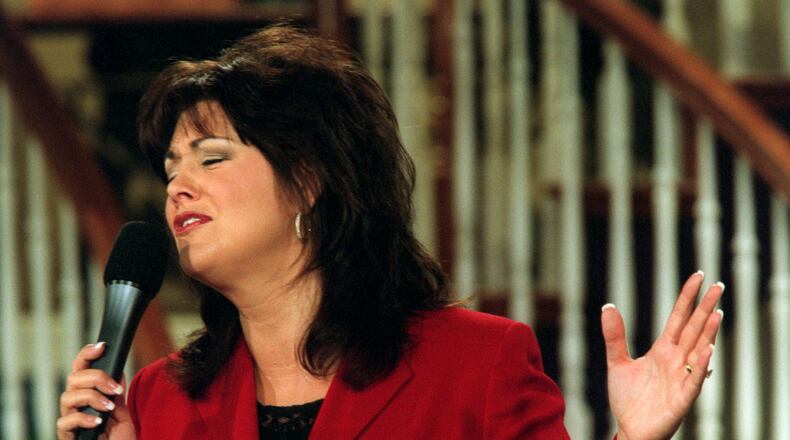 Television evangilist Joni Lamb sings a praise song during 'Celebration', a show that she and her husband Marcus host on the Daystar Network, on July 30, 2001 in Colleyville, Texas. (Lawrence Jenkins/The Dallas Morning News via AP)