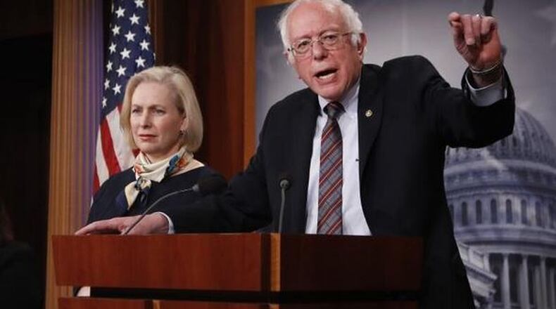 Sen. Bernie Sanders, I-Vt., right, with Sen. Tammy Duckworth, D-Ill., speaks to reporters during a news conference on March 14, 2017, on Capitol Hill in Washington. (AP Photo/Manuel Balce)