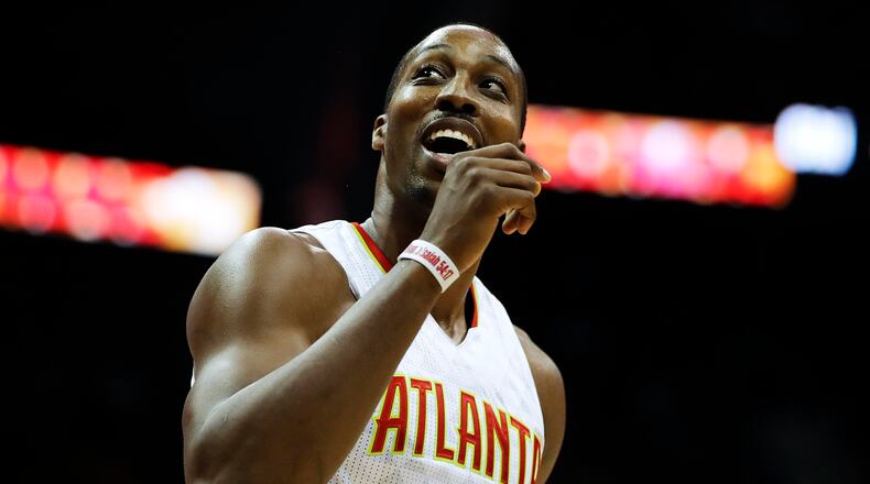 Atlanta Hawks' Dwight Howard smiles as he walks off the court.