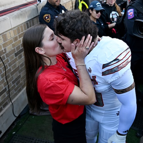 Emma Rodriguez, left, kisses her husband, Texas Tech linebacker Jacob Rodriguez, before the NCAA college football game between Texas Tech and BYU, Saturday, Nov. 8, 2025, in Lubbock, Texas. (AP Photo/Annie Rice)