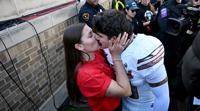 Emma Rodriguez, left, kisses her husband, Texas Tech linebacker Jacob Rodriguez, before the NCAA college football game between Texas Tech and BYU, Saturday, Nov. 8, 2025, in Lubbock, Texas. (AP Photo/Annie Rice)