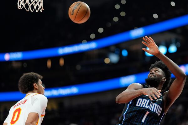Orlando Magic forward Jonathan Isaac (1) shoots against Atlanta Hawks forward Dominick Barlow (0) during the first half of an NBA basketball game, Sunday, April 13, 2025, in Atlanta. (AP Photo/Mike Stewart)