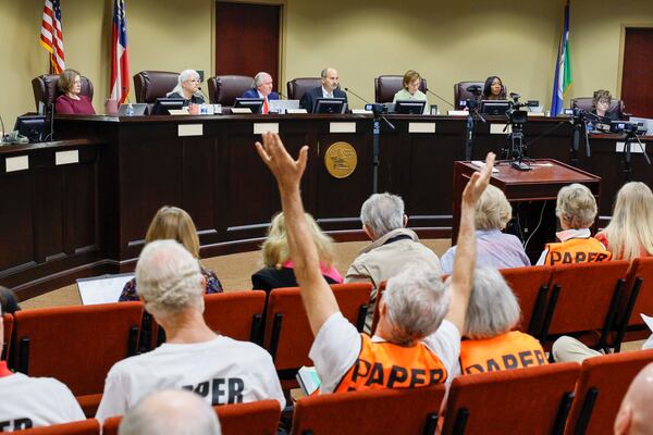 A supporter of paper ballots reacts as board members listen during a State Election Board meeting at Dawson County Government Center on Wednesday, April 15, 2026.
 (Miguel Martinez/AJC)
