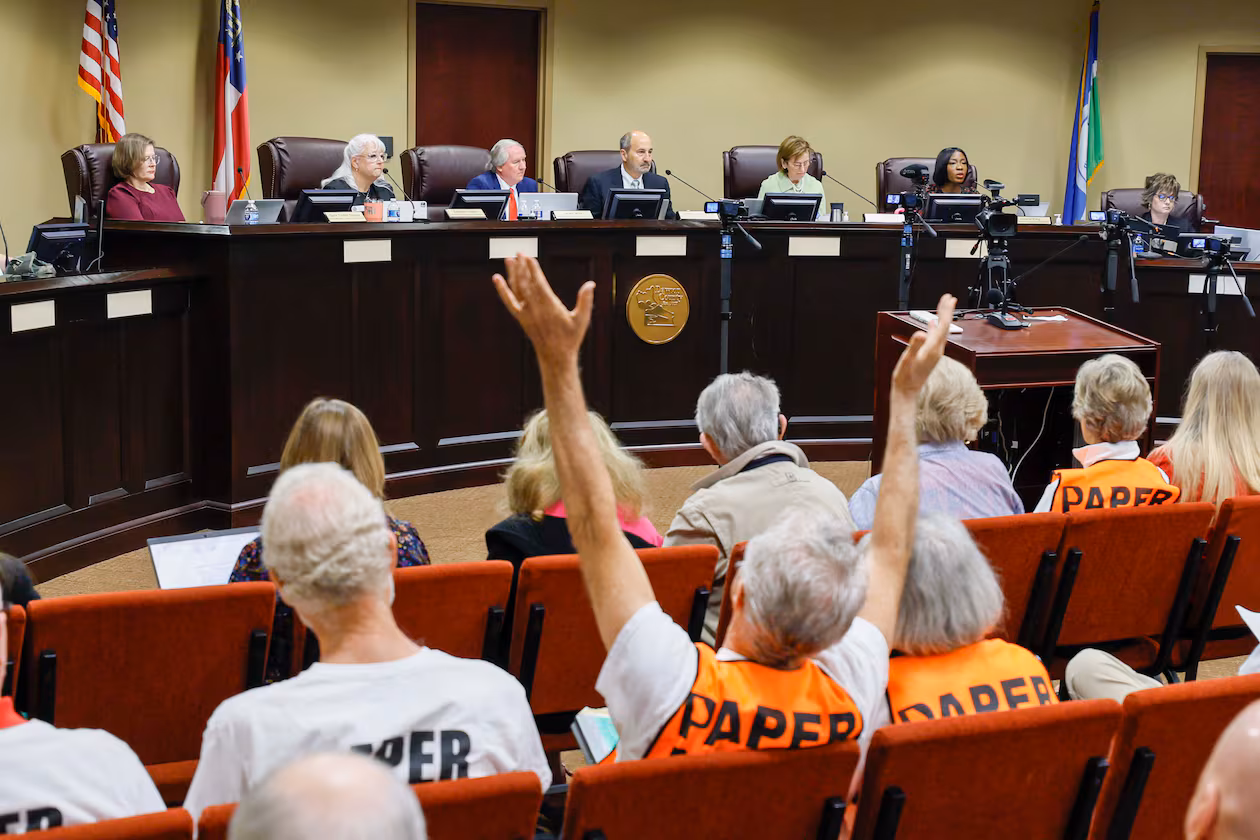 A supporter of paper ballots reacts as board members listen during a State Election Board meeting at Dawson County Government Center on Wednesday, April 15, 2026. (Miguel Martinez/AJC)
