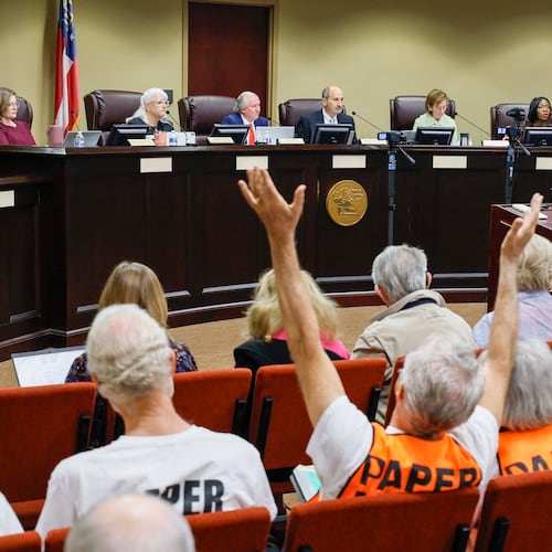 A supporter of paper ballots reacts as board members listen during a State Election Board meeting at Dawson County Government Center on Wednesday, April 15, 2026. (Miguel Martinez/AJC)