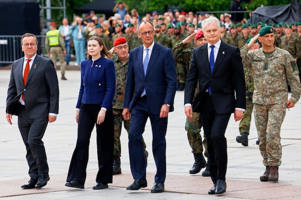 Lithuania's President Gitanas Nauseda, German Chancellor Friedrich Merz, Lithuania's defense minister Docile Sakaliene and German Defense Minister Boris Pistorius, from right, participate a formal inauguration of a German brigade for NATO's eastern flank in Vilnius, Lithuania, Thursday, May 22, 2025. (AP Photo/Mindaugas Kulbis)