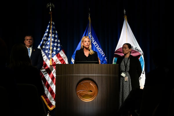 Attorney General Pam Bondi, center, speaks at a news conference at the Drug Enforcement Administration, Tuesday, July 15, 2025, in Arlington, Va. (AP Photo/Julia Demaree Nikhinson)