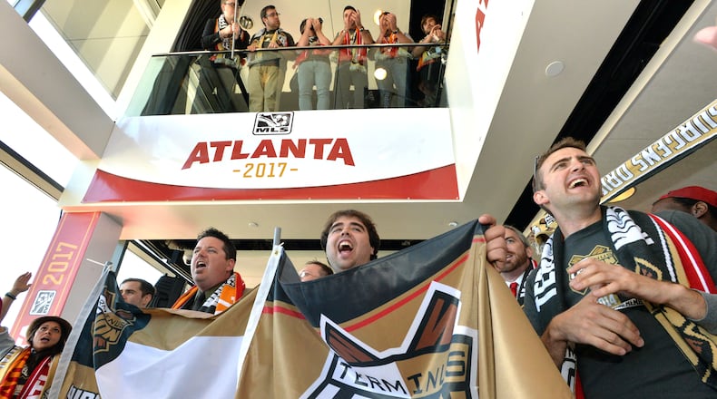 Soccer fans cheer before the official announcement event begins in downtown Atlanta on Wednesday, April 16, 2014. MLS commissioner Don Garber, Falcons owner Arthur Blank, Mayor Kasim Reed, executive director of GWCC Frank Poe and others officially announced that Atlanta will be the 22nd team in MLS on Wednesday downtown amidst a parade-like atmosphere. HYOSUB SHIN / HSHIN@AJC.COM