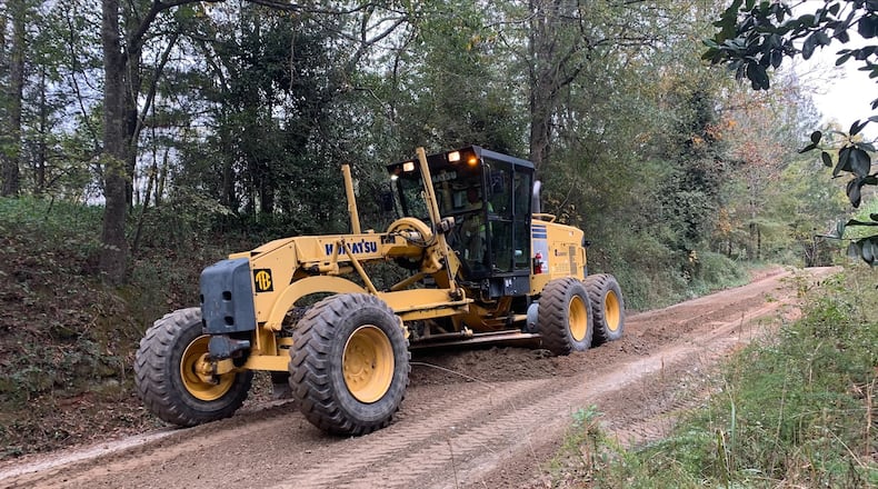 This photo, shared by Milton, shows a motor grader rolling down Lackey Road, home to the city's soon-to-open new greenspace and trails. The operator is a part-time Milton employee and Fulton County Public Works retiree with over 45 years of experience grading North Fulton’s gravel roads. (Courtesy City of Milton)