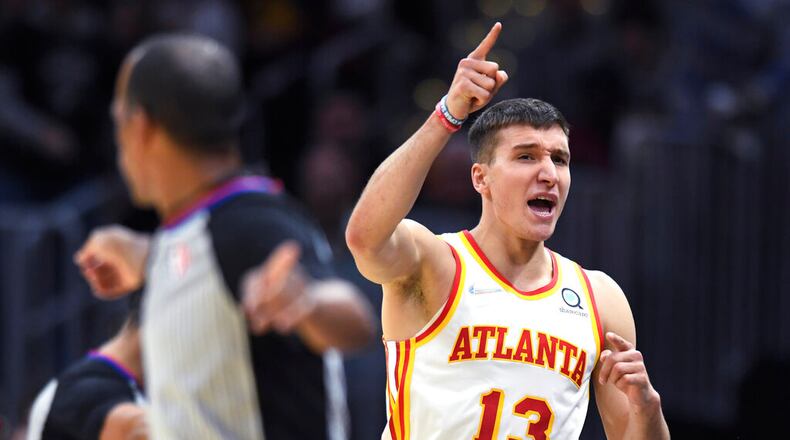 Atlanta Hawks' Bogdan Bogdanovic celebrates a turnover during the second half of the team's NBA play-in basketball game against the Cleveland Cavaliers on Friday, April 15, 2022, in Cleveland. (AP Photo/Nick Cammett)