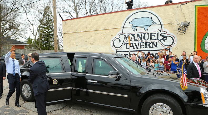 President Barack Obama waves to the crowd as he departs Manuel's Tavern, where he talked to college students and even played darts, in 2015. Customer service and great conversation have been hallmarks since the North Highland Avenue watering hole opened in 1956. Curtis Compton / ccompton@ajc.com