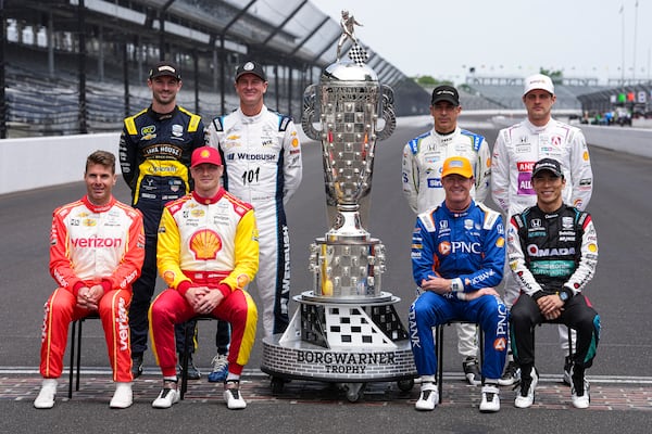 The former winners of the Indianapolis 500, top row, left to right, Alexander Rossi, Ryan Hunter-Reay, Helio Castroneves, of Brazil, and Marcus Ericsson, of Sweden, bottom bottom row, Will Power, of Australia, Josef Newgarden, Scott Dixon, of New Zealand, and Takuma Sato, of Japan, pose for a photo on the start/finish line before practice for the Indianapolis 500 auto race at the Indianapolis Motor Speedway in Indianapolis, Monday, May 19, 2025. (AP Photo/Michael Conroy)