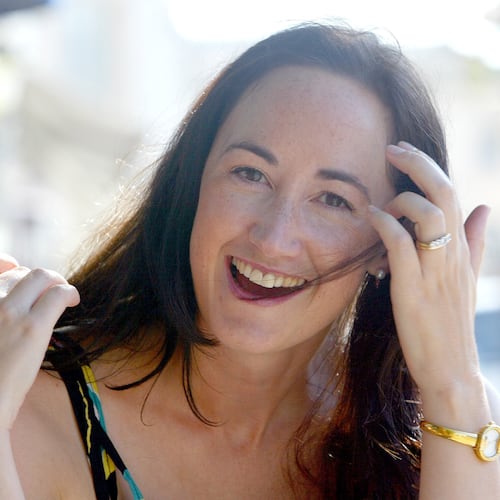 FILE - Author Sophie Kinsella poses on Wimbledon Village high street, London, Sept. 9, 2004. (AP Photo/Adam Butle, File)
