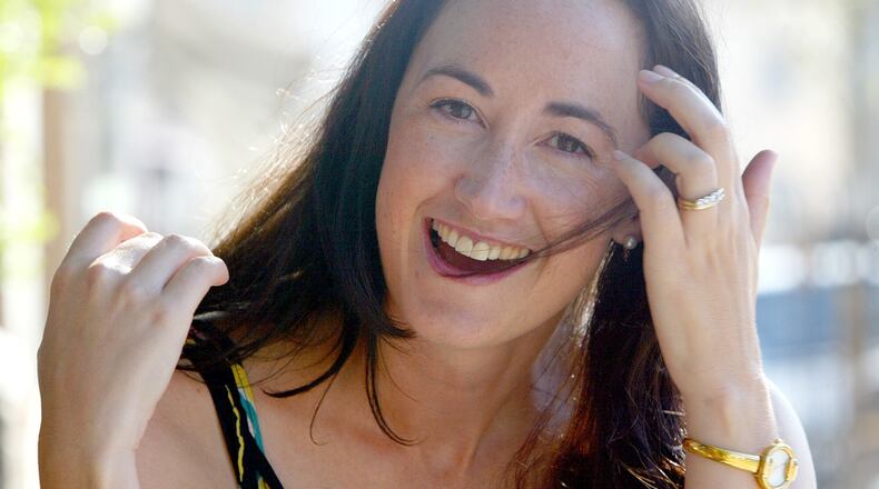 FILE - Author Sophie Kinsella poses on Wimbledon Village high street, London, Sept. 9, 2004. (AP Photo/Adam Butle, File)