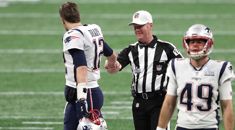 Patriots quarterback Tom Brady greets referee John Parry prior to Super Bowl LIII against Los Angeles Rams Feb. 3, 2019, at Mercedes-Benz Stadium in Atlanta.