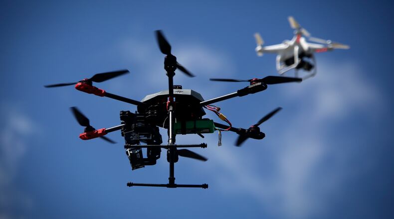 Drones fly in the sky outside Hacklab in Boynton Beach during International Drone Day activities March 14, 2015. (Bruce R. Bennett / The Palm Beach Post)