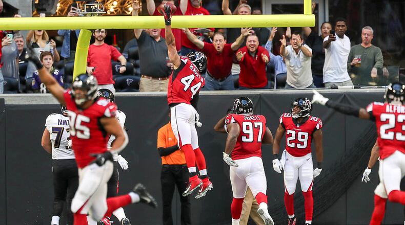 Atlanta Falcons defensive end Vic Beasley (44) dunks the football after intercepting the ball and running it back for touchdown during the first half of the game at Mercedes-Benz Stadium in Atlanta, Sunday, December 2, 2018. (ALYSSA POINTER/ALYSSA.POINTER@AJC.COM)