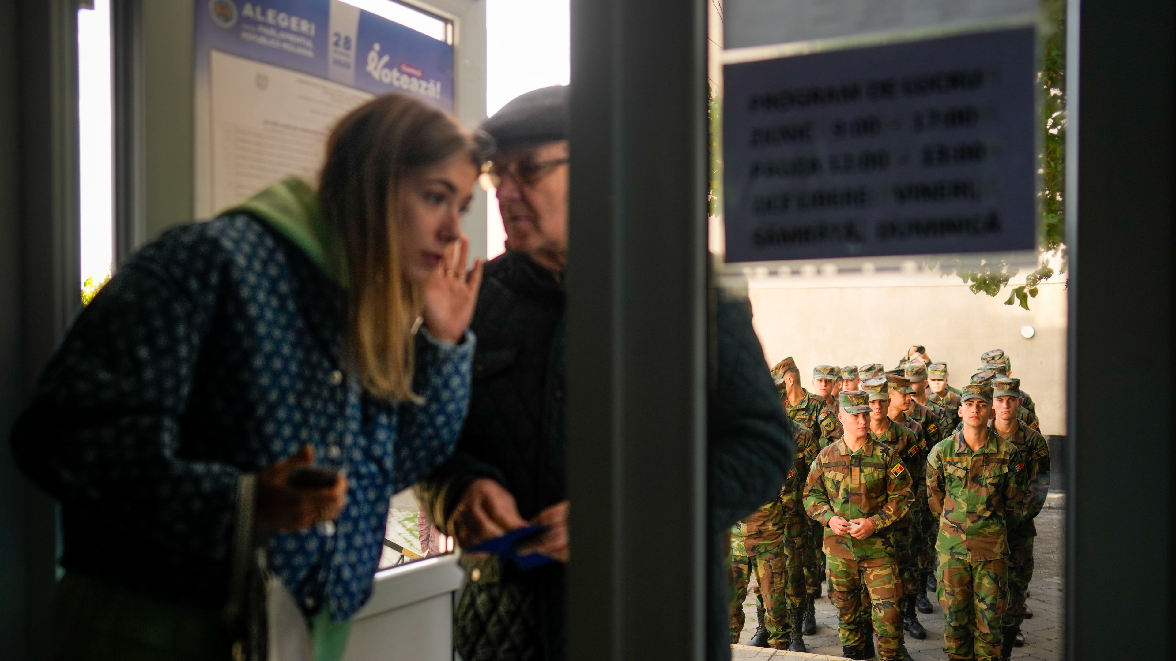 Soldiers wait outside a voting stations to cast their vote during a parliamentary election, in Chisinau, Moldova, Sunday, Sept. 28, 2025. (AP Photo/Vadim Ghirda)