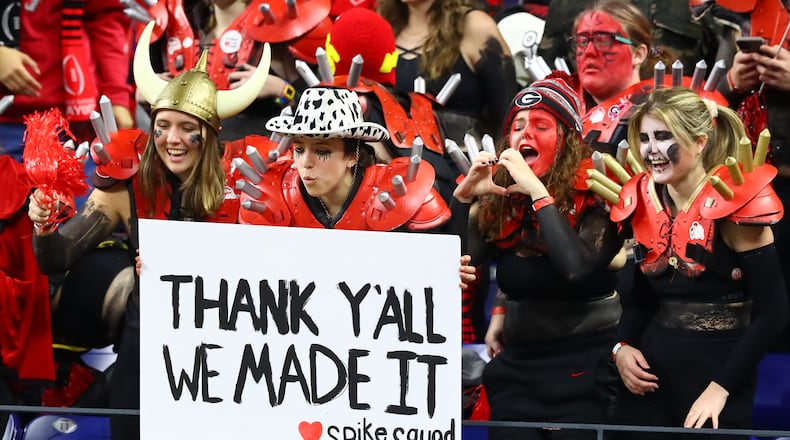 Members of the spike squad, who made it to the big game, show Georgia players some love as they take the field to prepare to play Alabama in the College Football Playoff Championship game on Monday, Jan. 10, 2022, in Indianapolis.  “Curtis Compton / Curtis.Compton@ajc.com”`