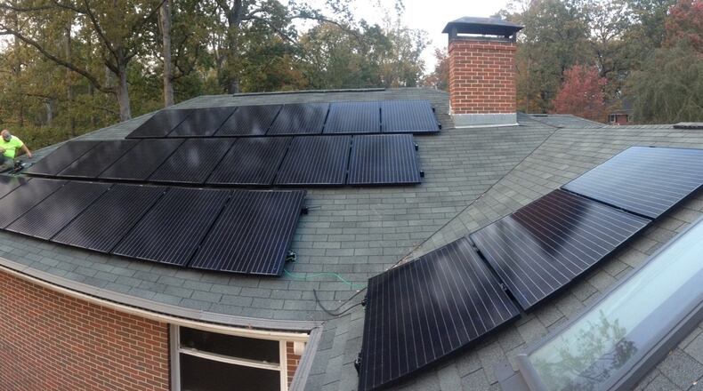 A worker installs solar panels on a Druid Hills home under Solarize Decatur-DeKalb’s program. Photo courtesy of Creative Solar USA.