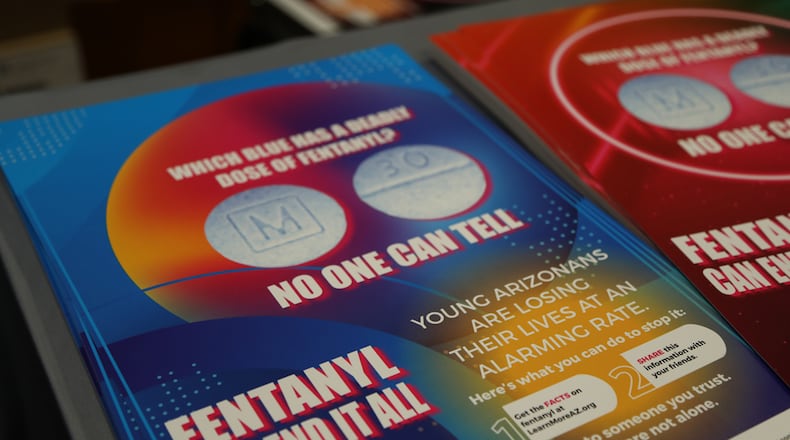 A flier at the September 2023 Arizona Drug Summit shows how visually similar lethal, fentanyl laced blue M30s appear to authentic Oxycodone (Macie Logan)