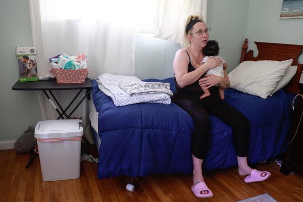 Ashley Allen holds her new daughter Reign at in their room at the Mary Lane House in Cobb County.  Sheltering Grace Ministry, which operates the home, assists homeless women with and their newborns.. (Natrice Miller/natrice.miller@ajc.com)  