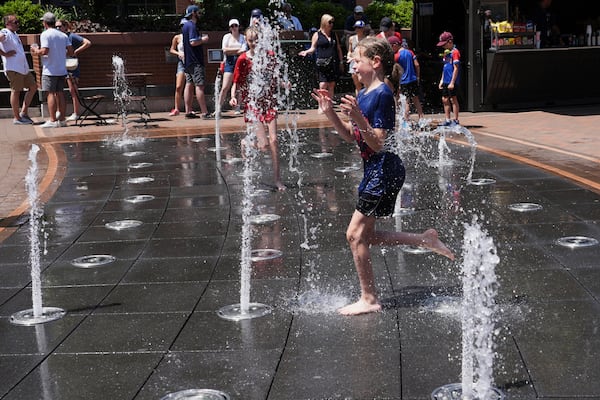 Jude Puroway cools off at a fountain during hot weather in Chicago, Sunday, June 22, 2025. (AP Photo/Nam Y. Huh)