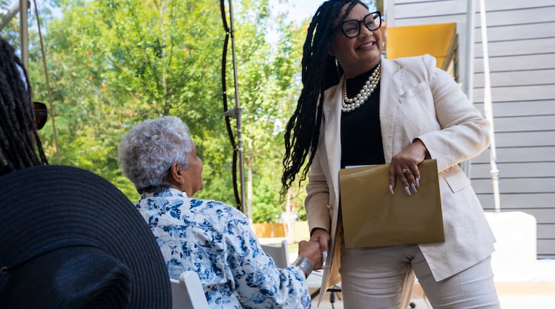 U.S. Representative Nikema Williams shakes hands with former Atlanta Mayor Shirley Franklin at an Atlanta Neighborhood Development Partnership Inc. housing unveiling event on Tuesday, Aug. 27, 2024 in Atlanta, Georgia. (Olivia Bowdoin for the AJC).