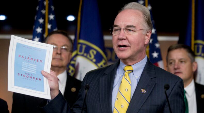 Representative Thomas "Tom" Price, a Republican from Georgia and chairman of the House Budget Committee, holds up a copy of the House Republicans' Fiscal Year 2016 budget proposal titled "A Balanced Budget for a Stronger America" during a news conference with other members of the budget committee in Washington, D.C., U.S., on Tuesday, March 17, 2015. U.S. House Republicans propose to balance the federal budget in less than 10 years by cutting spending by $5.5 trillion without raising taxes, the chamber's budget committee chairman said Tuesday in an opinion article. Photographer: Andrew Harrer/Bloomberg *** Local Caption *** Tom Price
