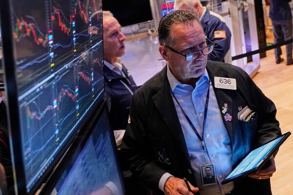 Trader Edward Curran, right, works on the floor of the New York Stock Exchange, Thursday, April 24, 2025. (AP Photo/Richard Drew)
