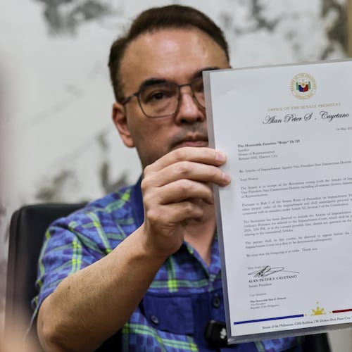 Philippine Senate President Alan Peter Cayetano holds a letter addressed to Lower House Speaker Faustino Dy III, acknowledging the Senate's receipt of the resolution containing the Articles of Impeachment against Vice President Sara Duterte, during a media briefing at the Senate in Pasay City on May 14, 2026.(AP Photo/Gerard Carreon)