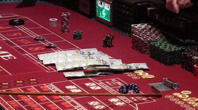 Cash, chips and dice on a craps table at a casino. AP file/Wayne Parry