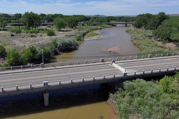 A historic bridge that crosses the Rio Grande is closed ahead of the monsoon due to concerns about a concrete pier being further scoured by high river flows in Española, New Mexico, on June 13, 2025. (AP Photo/Susan Montoya Bryan)