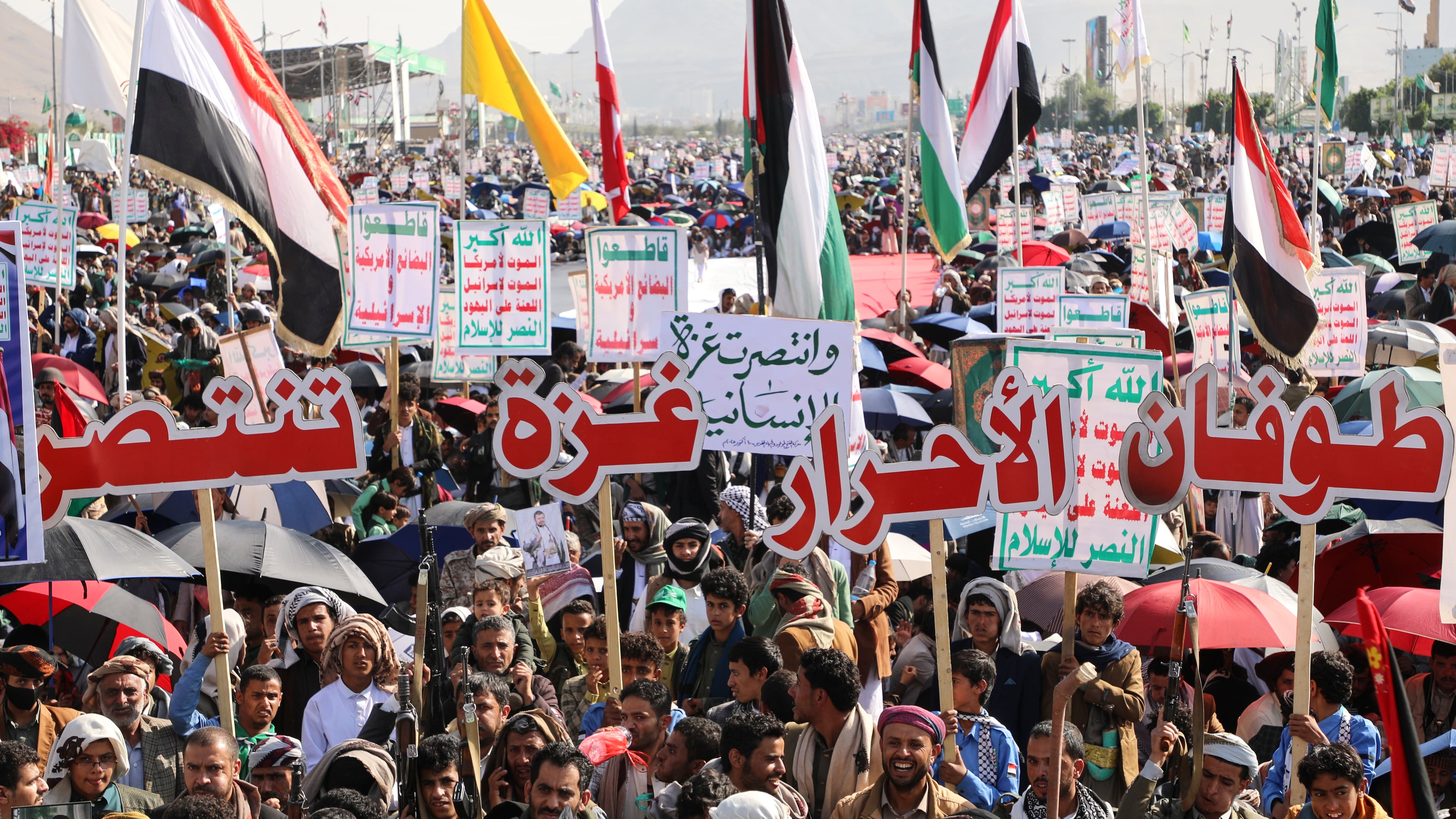 Houthi supporters celebrate following the announcement that Israel and Hamas have agreed to the first phase of a peace plan to pause the fighting, in Sanaa, Yemen, Friday, Oct. 10, 2025. Arabic reads, "Gaza victory". (AP Photo/Osamah Abdulrahman)
