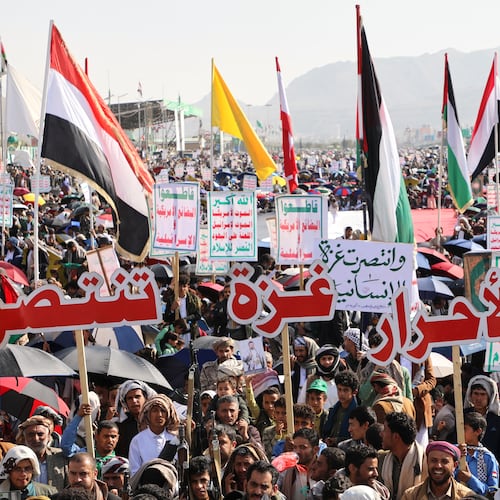 Houthi supporters celebrate following the announcement that Israel and Hamas have agreed to the first phase of a peace plan to pause the fighting, in Sanaa, Yemen, Friday, Oct. 10, 2025. Arabic reads, "Gaza victory". (AP Photo/Osamah Abdulrahman)