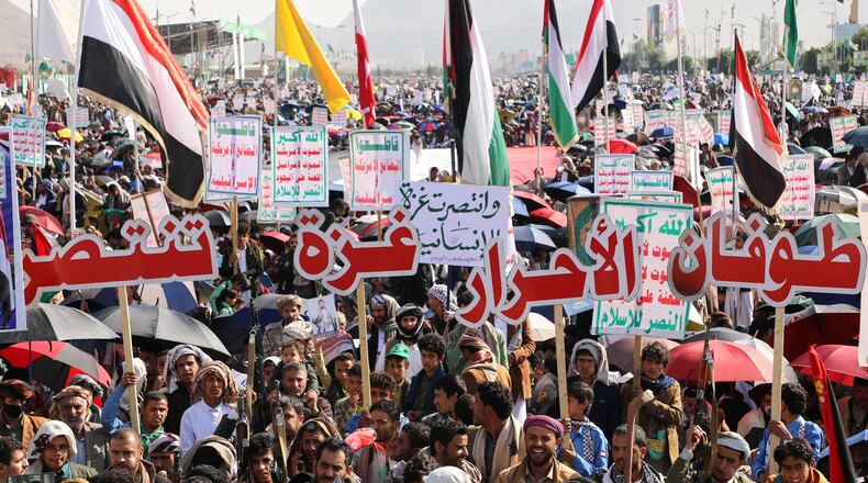 Houthi supporters celebrate following the announcement that Israel and Hamas have agreed to the first phase of a peace plan to pause the fighting, in Sanaa, Yemen, Friday, Oct. 10, 2025. Arabic reads, "Gaza victory". (AP Photo/Osamah Abdulrahman)