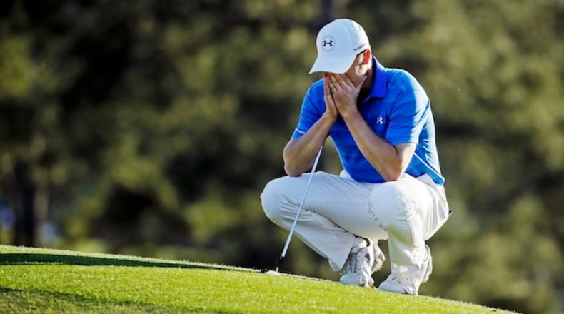 Jordan Spieth pauses on the 18th green before putting out during the final round of the Masters golf tournament Sunday, April 10, 2016, in Augusta, Ga. (AP Photo/Chris Carlson)
