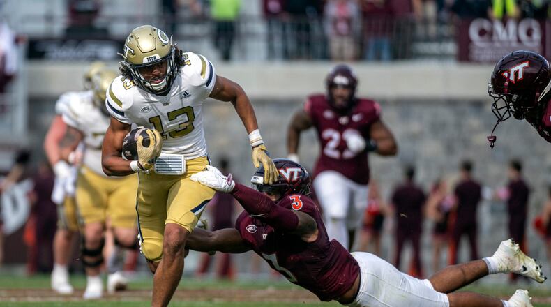 Georgia Tech's Isiah Canion, left, gets by Virginia Tech's Sam Brumfield (3) during the second half of an NCAA college football game, Saturday, Oct. 26, 2024, in Blacksburg, Va. (AP Photo/Robert Simmons)