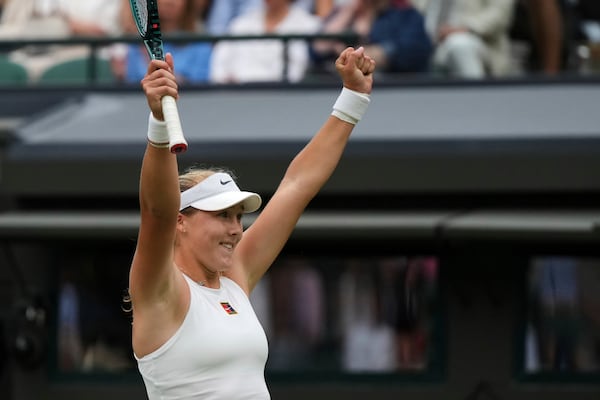 Mirra Andreeva of Russia celebrates winning the women's singles third round match against Hailey Baptiste of the U.S. at the Wimbledon Tennis Championships in London, Saturday, July 5, 2025.(AP Photo/Alastair Grant)
