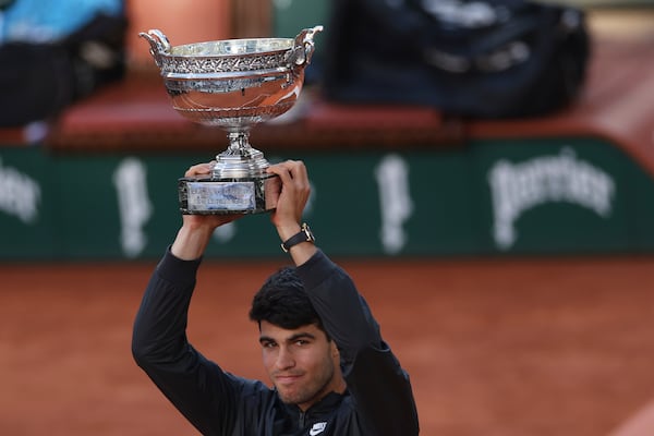 FILE - Winner Spain's Carlos Alcaraz celebrates with the trophy as he won the men's final match of the French Open tennis tournament against Germany's Alexander Zverev at the Roland Garros stadium in Paris, June 9, 2024. (AP Photo/Aurelien Morissard, File)