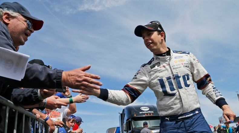 Brad Keselowski greets fans during driver introductions before the NASCAR Cup Series auto race at Martinsville Speedway in Martinsville, Va., Sunday, April 2, 2017. (AP Photo/Steve Helber)