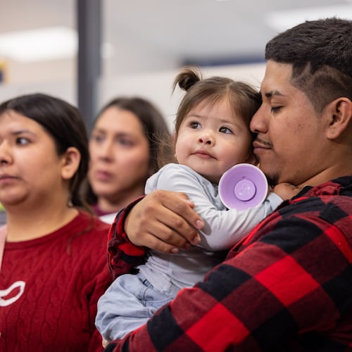 Rafael Veraza holds his young daughter, Ariana, during a press conference decrying federal agents use of force in Little Village on the Southwest Side, Chicago, Sunday, Nov. 9, 2025. (Candace Dane Chambers/Chicago Sun-Times via AP)