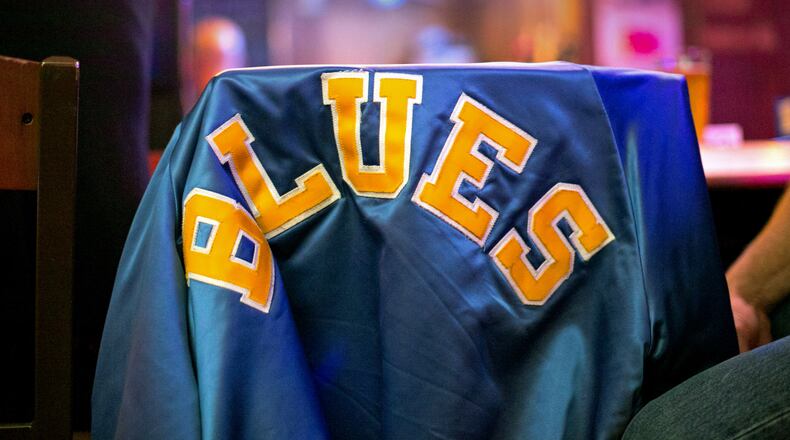 A blues music fans has a "Blues" jacket on her chair at Darwin's Burgers & Blues Saturday, April 2, 2016, in Marietta, Ga. Darwin's Burgers & Blues recently won the Keeping the Blues Alive award from The Blues Foundation in Memphis. PHOTO / JASON GETZ