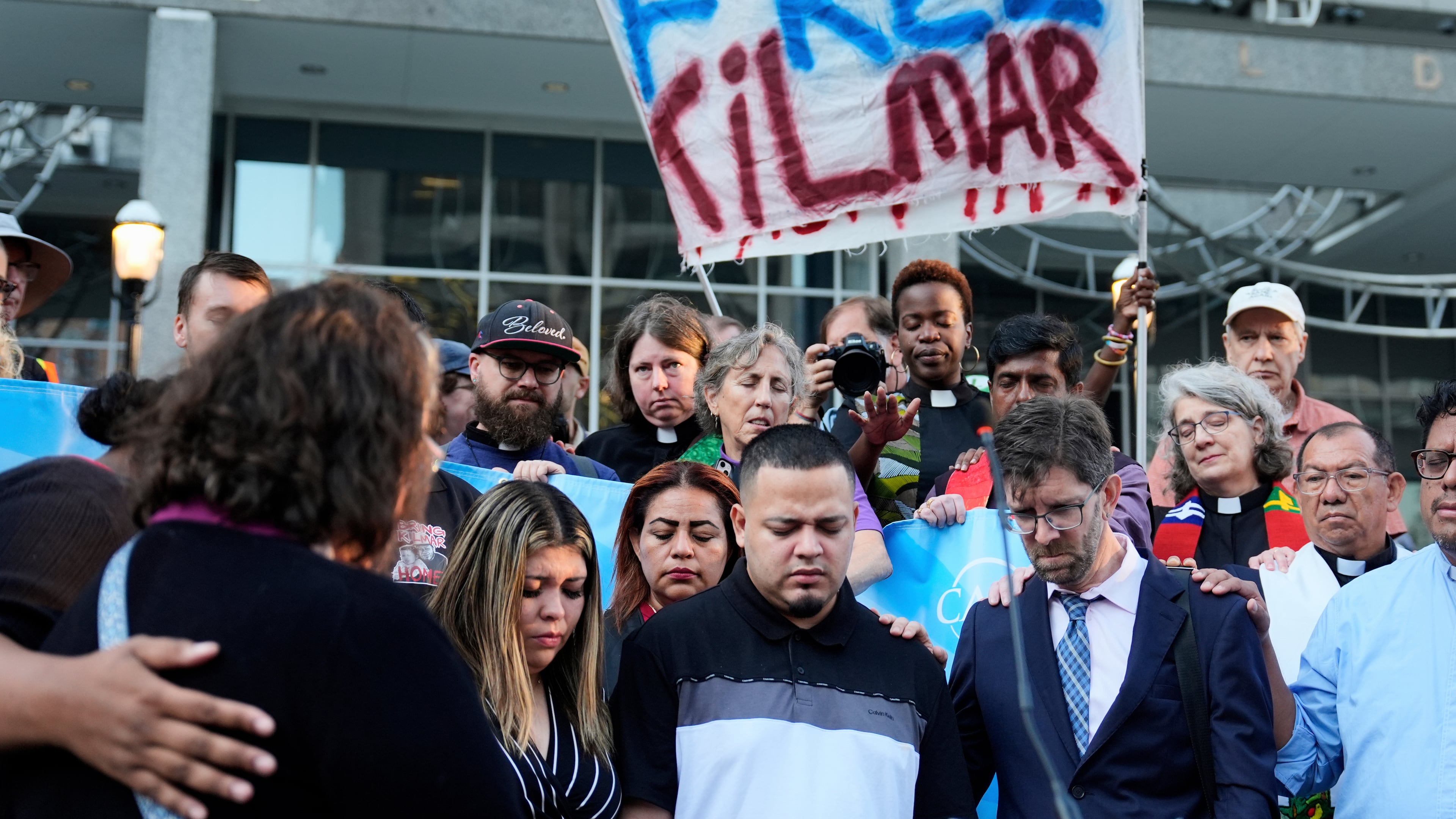 FILE - Jennifer Vasquez Sura, front left, her husband Kilmar Abrego Garcia, front center, and Attorney Simon Sandoval-Moshenberg, front right, attend a protest rally at the Immigration and Customs Enforcement field office in Baltimore, Monday, Aug. 25, 2025, to support Kilmar Abrego Garcia. (AP Photo/Stephanie Scarbrough, File)