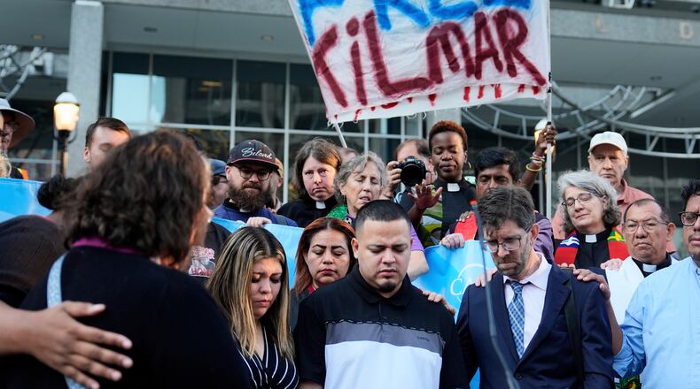 FILE - Jennifer Vasquez Sura, front left, her husband Kilmar Abrego Garcia, front center, and Attorney Simon Sandoval-Moshenberg, front right, attend a protest rally at the Immigration and Customs Enforcement field office in Baltimore, Monday, Aug. 25, 2025, to support Kilmar Abrego Garcia. (AP Photo/Stephanie Scarbrough, File)