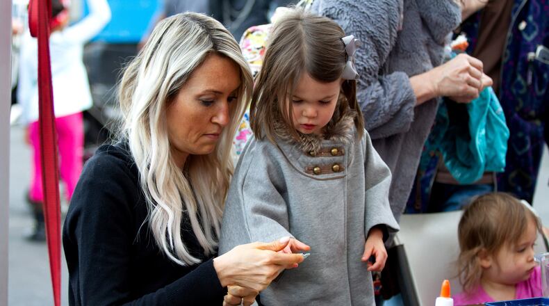Atlantic Station is hosting its first ever Christmas in July event at 6:30 p.m. Tuesday. The holiday-themed event will include a special screening of “The Grinch,” the 3D animation released last year. In this photo, Sara Luksin and her daughter Isabelle, 3, make Christmas wreaths during the Light the Station 2018 holiday event Saturday, November 17, 2018, at Atlantic Station in Atlanta. (Photo: STEVE SCHAEFER / SPECIAL TO THE AJC)