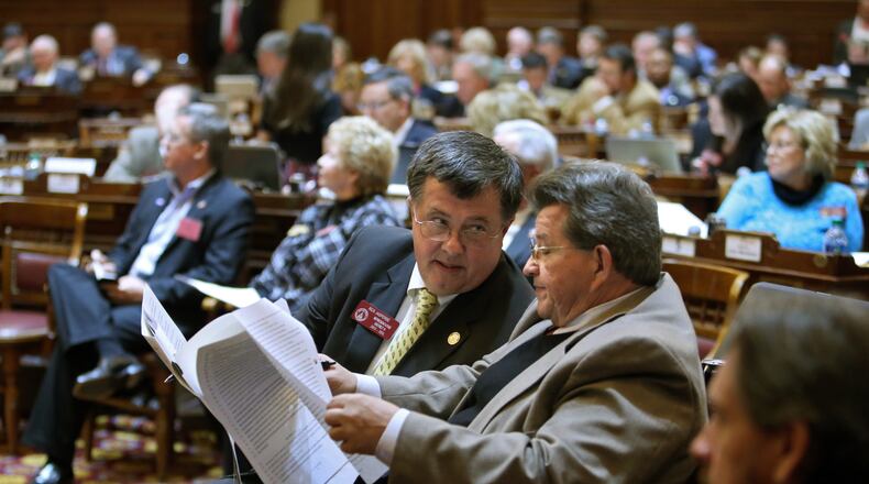 Rep. Rick Jasperse, R-Jasper, center, and Rep. Alan Powell, R-Hartwell, right, look over portions of Senate Bill 101 during the debate on the bill on Legislative Day 37 in the House Chambers Friday morning in Atlanta, Ga., March 22, 2013. Rep. Jasperse is the House sponsor of the bill. Rep. Powell is the Chairman of the House Public Safety and Homeland Security Committee where all of the changes to the bill occurred. The House passed SB 101 as amended 116 to 55 votes.