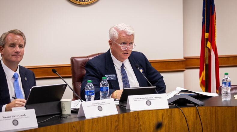 State Sen. Randy Robertson, R-Cataula, chairman of the Department of Corrections Facilities Study Committee, and Sen. John Albers, R-Roswell, listen to testimony at a committee meeting in August.