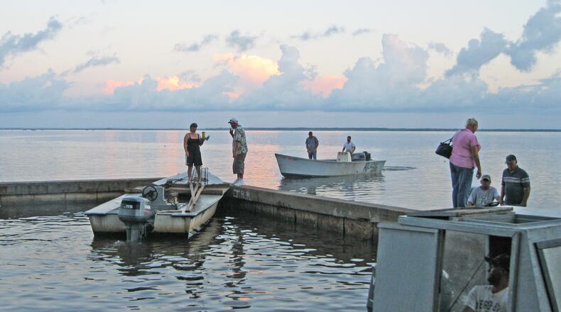 Oystermen head out early from Eastpoint, Fla. for a day of fishing on the Apalachicola Bay. DAN CHAPMAN / DCHAPMAN@AJC.COM