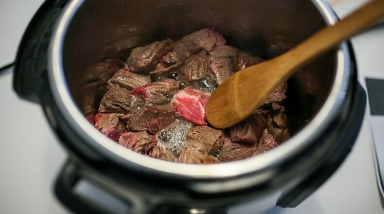 Cubes of beef are sauteed in the Instant Pot for a beef barbacoa tacos recipe. (Kimberly P. Mitchell/Detroit Free Press/TNS)